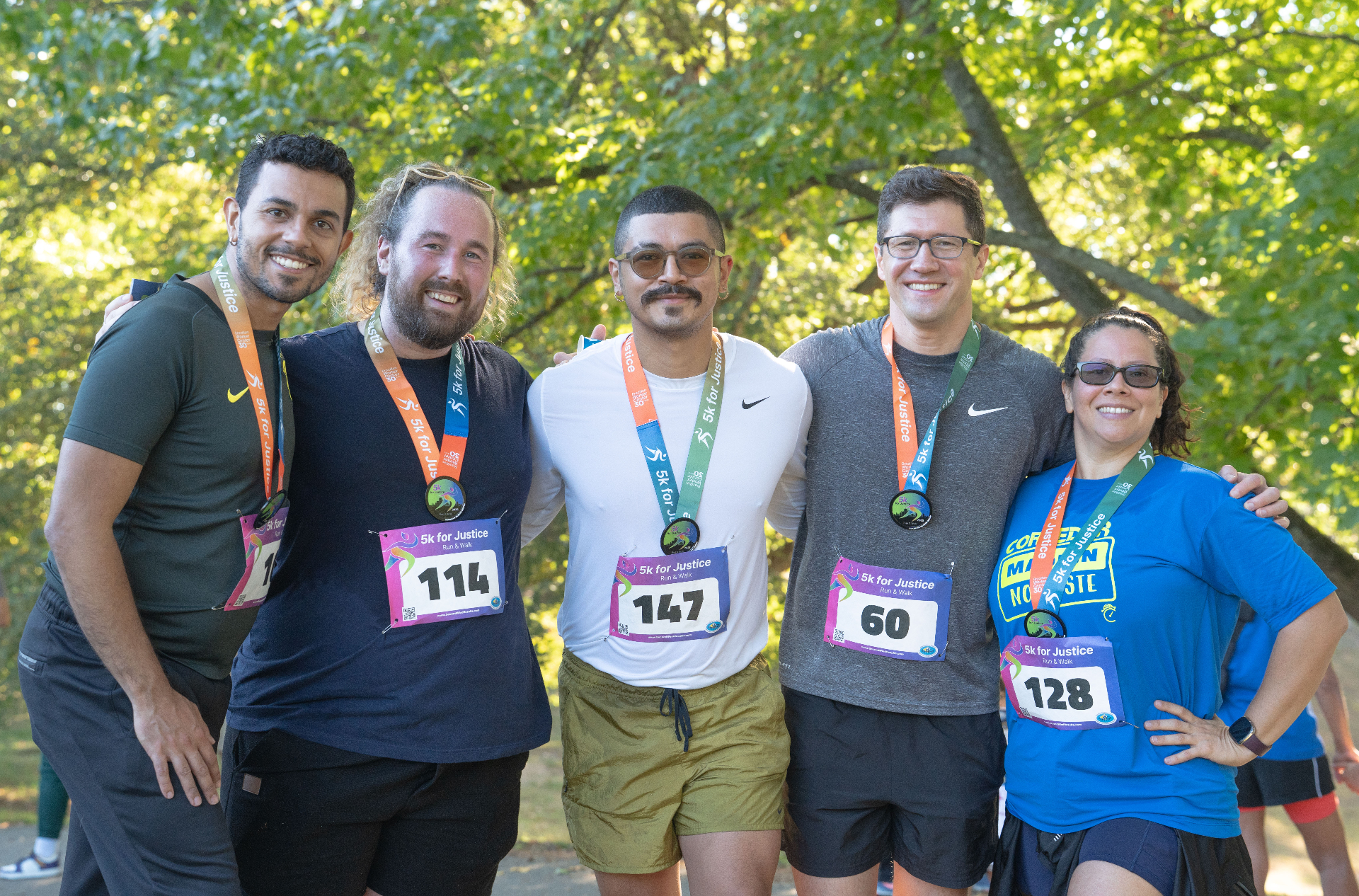 Close-up of diverse runners' feet hitting the pavement